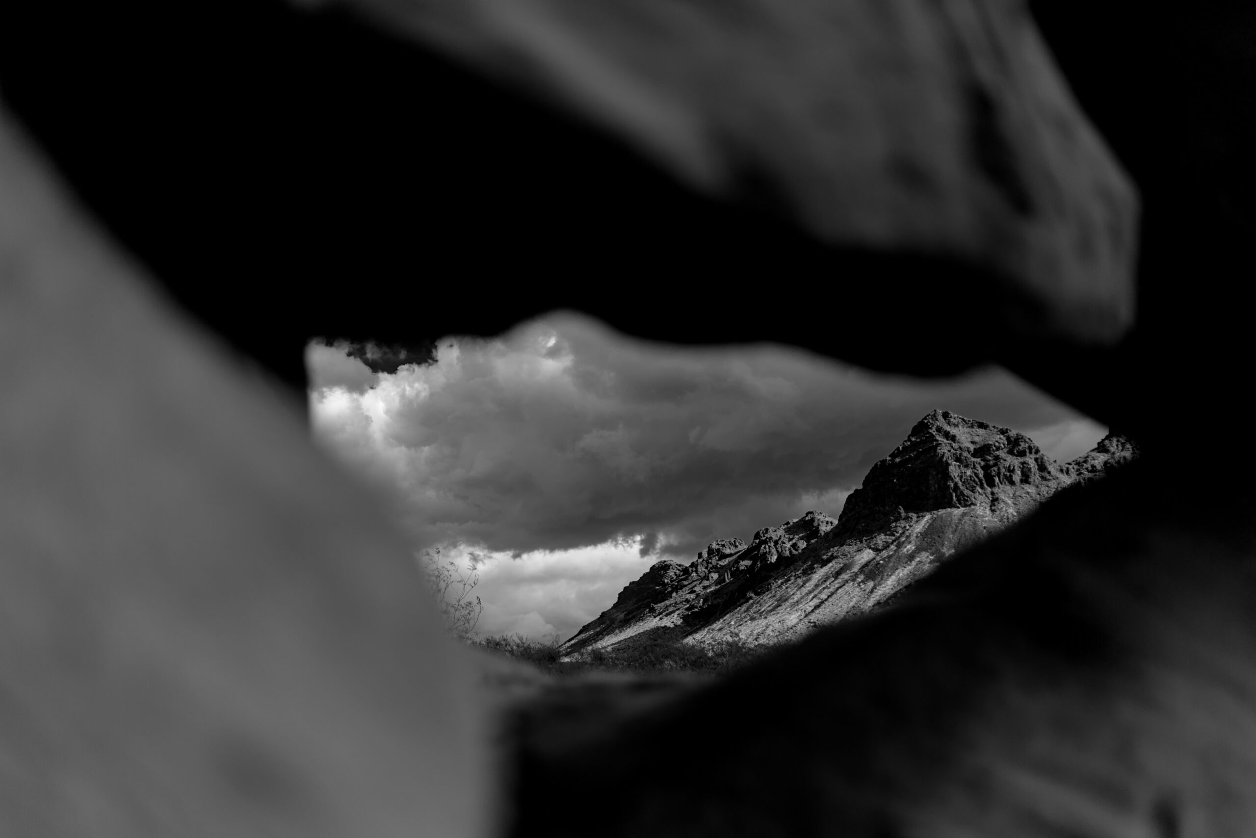 Mountains are framed in the distance, by red rocks. The whole picture is in black in white though.